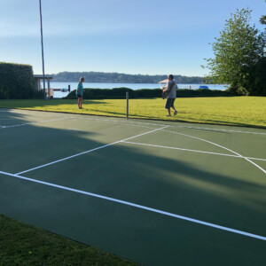 Side view of a backyard tennis court